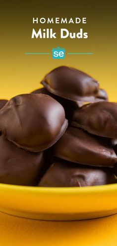 a yellow bowl filled with chocolate covered cookies on top of a yellow tablecloth and the words homemade milk duds