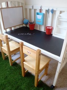 a child's desk with chalk writing on the top and two stools underneath it