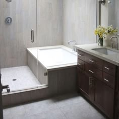 a bathroom with a sink, mirror and shower in it's corner stall area