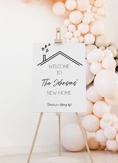 a welcome sign with balloons surrounding it in front of a white wall that reads, welcome to the johnson's new home