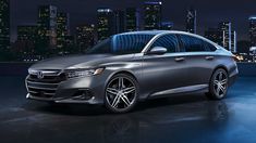 the new honda accord sedan is shown in front of a cityscape at night