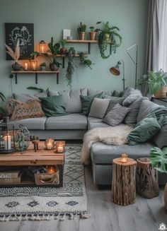 a living room filled with lots of furniture and plants on the wall above it's coffee table