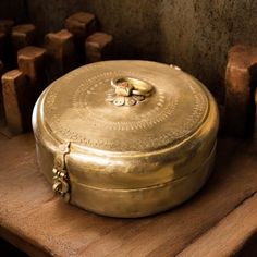 a gold box sitting on top of a wooden table