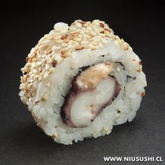 a sushi roll with sesame seeds on it