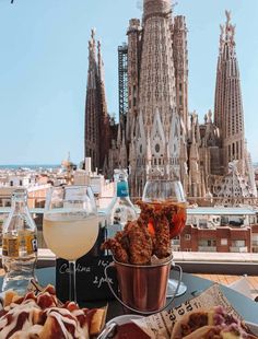 food and drinks on a table in front of a view of the saffroni cathedral