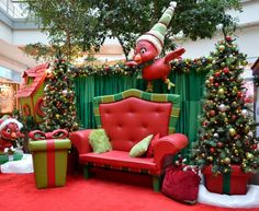 a living room decorated for christmas with presents on the floor and inflatable decorations