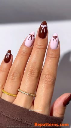 a woman's hand with some brown and pink nail polishes on her nails