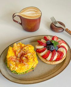 two pastries on a plate next to a cup of coffee