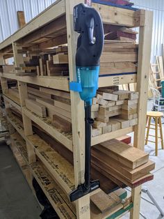 a machine that is sitting on top of some pallets in a building with wood