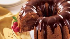 a bundt cake with chocolate icing and raspberries