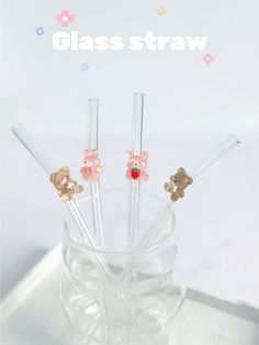 four glass straws with teddy bears on them in a clear cup and the words class straw written below