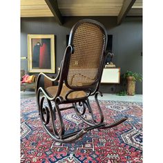 a wooden rocking chair sitting on top of a rug