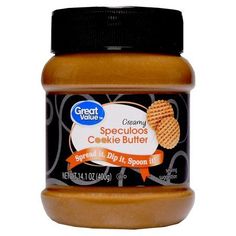 a jar of peanut butter with an orange label on the front and black cap around the top