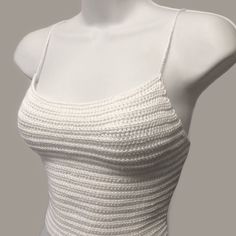 a mannequin is wearing a white top