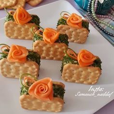 crackers decorated with flowers and leaves on a plate