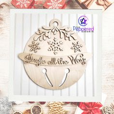 a christmas ornament with the words angel all the way on it, surrounded by presents