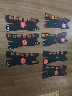 some black and orange stickers on a wooden floor