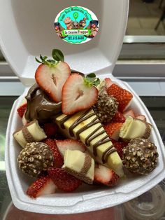 strawberries and chocolate in a foam container