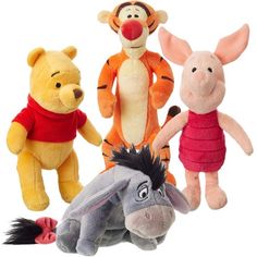 winnie the pooh, tigger, and piggy stuffed animals are lined up