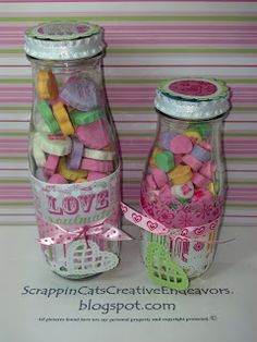 two glass jars filled with candy on top of a table