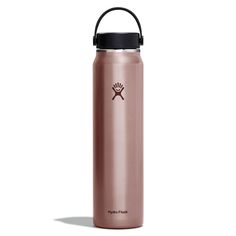 the hydro flask water bottle is shown in rose gold with black lid and handle