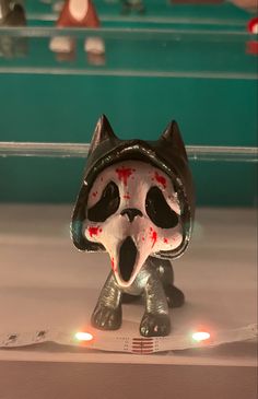 a close up of a figurine with blood on it's face and eyes