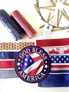 some patriotic items are laid out on a table with ribbons and other things to sew