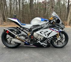 a motorcycle parked on the street in front of some trees