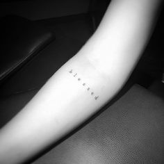 a woman's arm with the word love written in cursive font on it