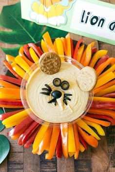 a lion face made out of carrots and crackers on top of a plate