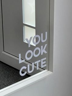 the words you look cute are cut out of an office door