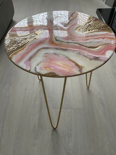 a table that has some kind of design on it, sitting in a living room