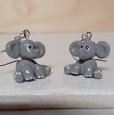 "Cute Handmade Elephant Dangle Earrings! These Handmade Elephants make the perfect gift for any occasion!  These Handmade Dangle Earrings are made from Polymer Clay with Nickel-Free Iron Earrings. The Elephants Measure about 3/4\" by 3/4\" by 3/4\". Please note that due to the handmade nature of these products minor variations can occur." Elephant Earrings Clay, Handmade Elephant, Earrings Handmade Dangle, Etsy Earrings Dangle, Handmade Natural, Polymer Clay, Jewelry Earrings Dangle, Elephant, Dangle Drop Earrings