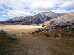 people are walking on a trail in the mountains