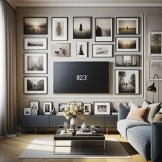 a living room filled with furniture and framed pictures on the wall above a flat screen tv