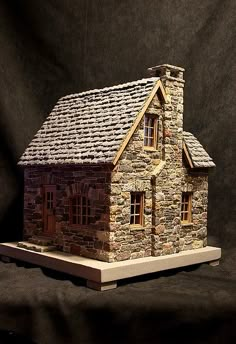 a small house made out of bricks on a black background