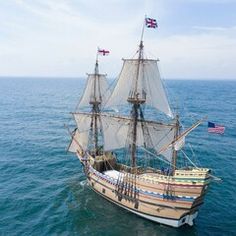 an old sailing ship in the middle of the ocean