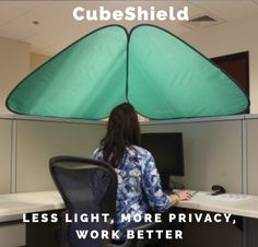 a woman sitting in an office cubicle with the caption, less light, more privacy, work better