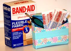 a box of bandages sitting on top of a table next to a package of fabric