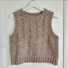 a knitted sweater hanging on a white door