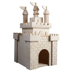 a model of a castle made out of white bricks and wood with turrets on top