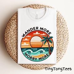 Embrace the beach life with this "Wander More Worry More" t-shirt, featuring a tropical sunset and palm tree graphic. Perfect for ocean lovers, beachgoers, and those who love coastal adventures. Ideal for summer vacations, beach trips, and sun-soaked getaways. 📢 Please check all photos for details. 📢 How to Order: 1. Select your shirt size, and color from the drop-down menu. 2. Add any customization details via the "Add message to Seller" link at checkout. 3. If ordering multiple items, add ea Summer Vacation T-shirt With Palm Tree Print, Beachy Relaxed Fit T-shirt With Palm Tree Print, Palm Tree Print Vacation T-shirt, Relaxed Fit Palm Tree Print T-shirt For Vacation, Beachy Relaxed Fit Palm Tree Print T-shirt, Summer Vacation Shirt, Summer Graphic Tee, Tree Graphic, Beach T Shirts