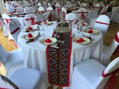 the tables are set with white and red linens