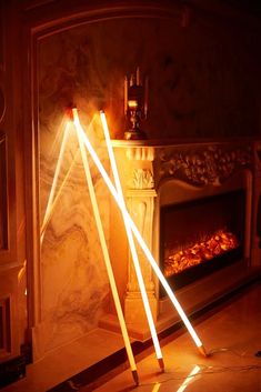 two wooden sticks in front of a fireplace with light coming from the top and bottom