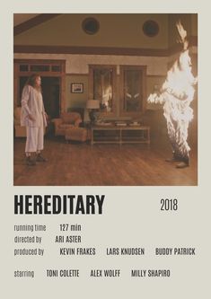 there is a poster for hereditary with a woman standing in the living room