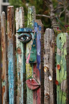 a wooden fence with an eye painted on it