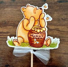 a sticker depicting a bear sitting on top of a barrel with honey in it