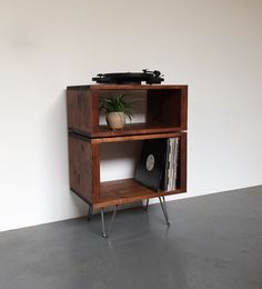 an old record player on top of a wooden shelf