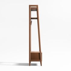 a tall wooden shelf sitting on top of a white floor