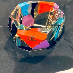 ****Rare**** Chanel Large Geometric Multicolor Faceted Lucite Clamper Bracelet With Double Cc Logo. From The Fall 2007 Collection Gold-Tone Metal With Geometric Motif Width 2" Hinge & Magnetic Closures In Very Good Preowned Condition, Slight Scratches Throughtout No Original Box Chanel Charm Bracelet, Chanel Cuff Bracelet, Black Shearling Coat, Chanel Cuff, Chanel Bracelet, Lucky Charm Bracelet, Jewelry Chanel, Geometric Motif, Crystal Choker Necklace